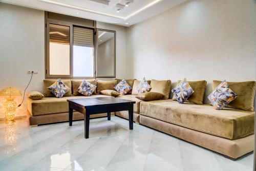 a living room with a couch and a table at jaws wave imsouane in Imsouane