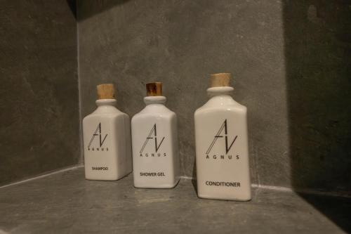 three white bottles sitting next to each other on a counter at Agnus Unawatuna in Unawatuna