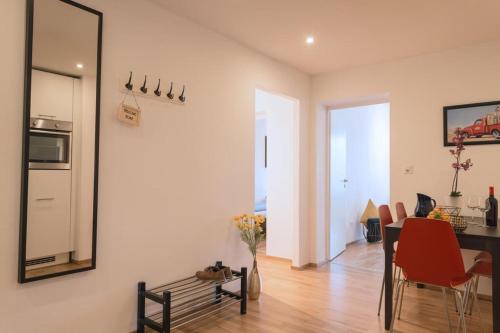 a kitchen and dining room with a table and a mirror at HITrental Chapel Bridge Apartments in Luzern