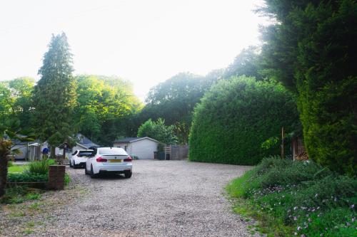 a white car is parked in a driveway at The Bungalow by TAS in Knebworth