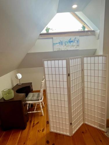 a room with a window and a table and a chair at The Lakeview Loft in Port Colborne