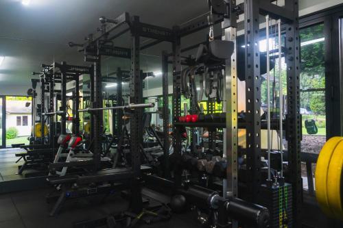 a gym filled with lots of machines at The Bungalow by TAS in Knebworth
