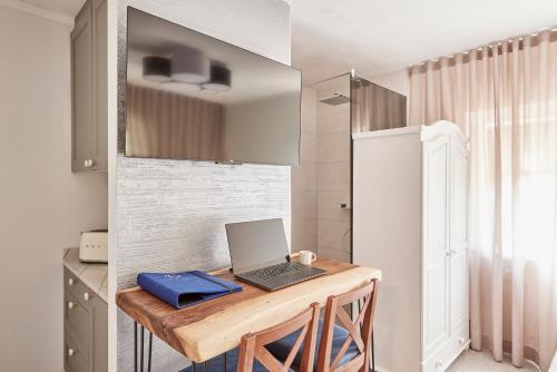 a kitchen with a desk with a laptop on it at Casa Di Pietra in Maria Saal