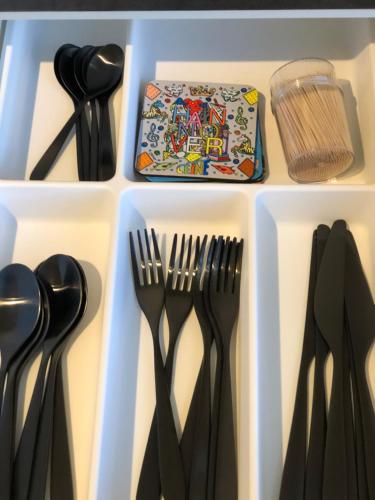 a drawer filled with utensils in a refrigerator at Emilys 3 Room Apartment 70 qm in Hannover