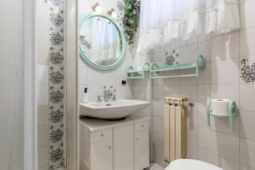 a bathroom with a sink and a mirror at Villetta Girasole in Torre del Lago Puccini