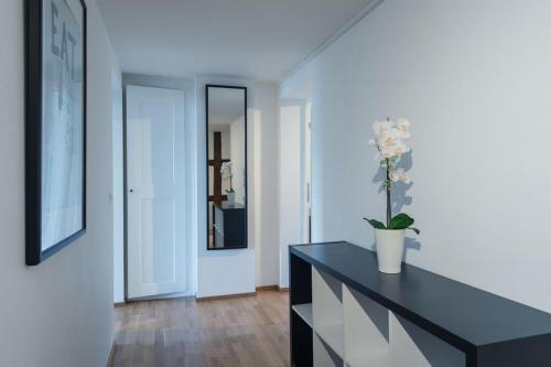 a living room with a black dresser and a mirror at HITrental Chapel Bridge Apartments in Luzern