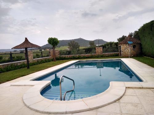 a swimming pool in a yard with a fence at Casa rural los Cuartos in San Benito de la Contienda