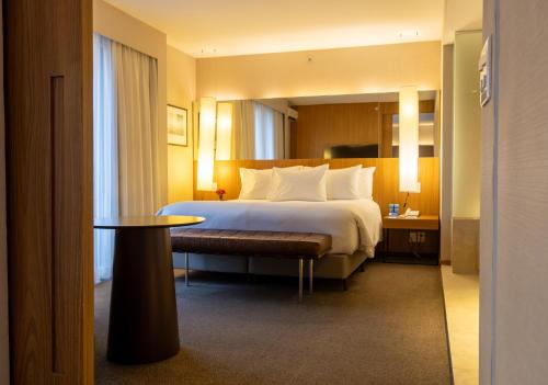 a hotel room with a bed and a table at Radisson Blu São Paulo in Sao Paulo
