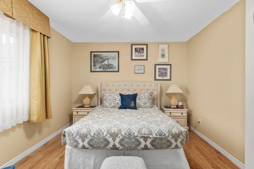 a bedroom with a bed with two night stands and two lamps at Lakeshore Inn in Cold Lake