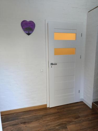 a room with a door and a heart on the wall at TOSKANA Nadarzyn in Nadarzyn