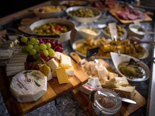 a table full of food with cheese and other foods at Quality Hotel Tønsberg in Tønsberg
