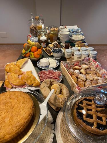 a table topped with lots of different types of food at Tenuta Pizzone Wine Resort in Rivanazzano