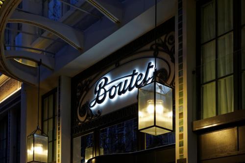 a sign for a store on the side of a building at Boutet Bastille Hotel Paris - MGallery Collection in Paris