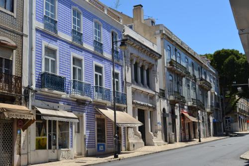 a row of blue buildings on a city street at TryLisbon Alcântara in Lisbon