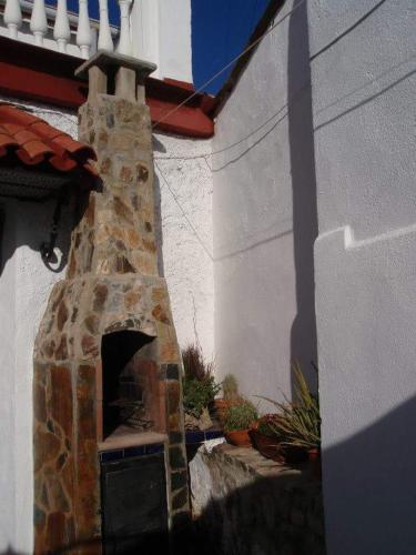 a stone oven in the side of a house at Los romeros in Santa Olalla del Cala