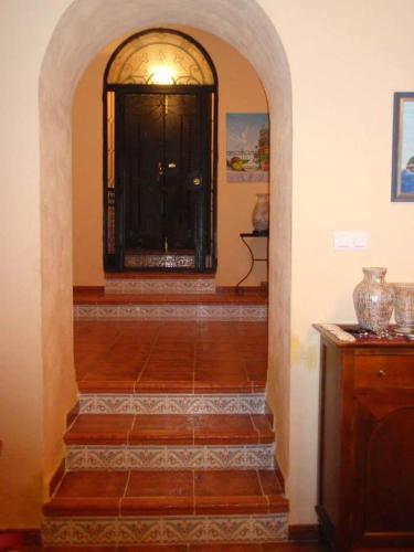 an entrance to a room with a door and stairs at Los romeros in Santa Olalla del Cala