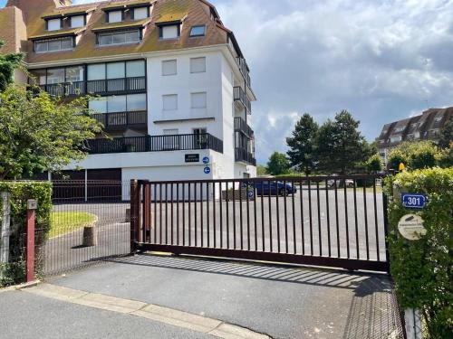 a metal gate in front of a building at Super Deauville appartement 2 pièces cosy proche plage plein sud in Villers-sur-Mer