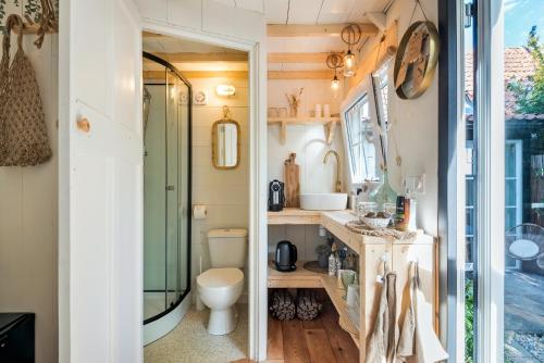 a small bathroom with a toilet and a sink at Tiny house Zaandam in Zaandam