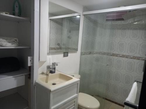 a white bathroom with a sink and a shower at apartamento 3 habitaciones cerca al parque del poblado in Medellín