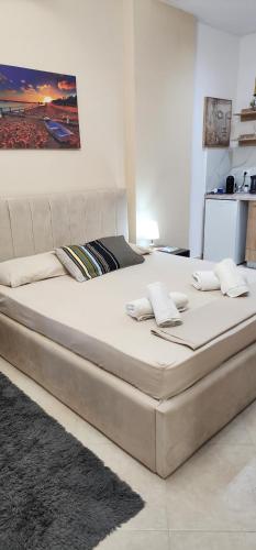 a large bed in a white room with at Rei's room in the city center in Durrës