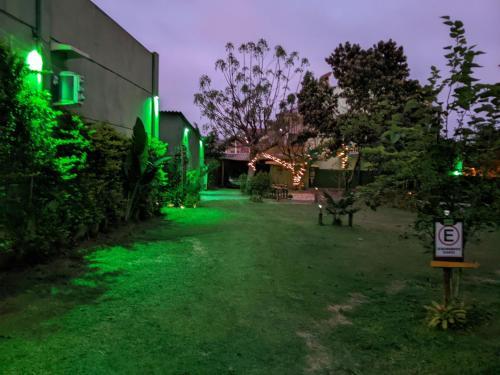 a yard lit up with green lights at night at Green Lodge Eco Life Hotel in Florianópolis