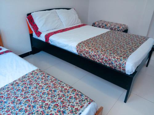 two beds sitting next to each other in a room at Hermosa casa de descanso en Tocaima in Tocaima