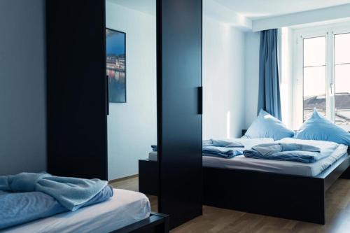 a bedroom with two beds and a window at HITrental Chapel Bridge Apartments in Luzern