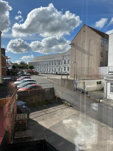 a view of a parking lot with cars parked at Niollo Hotel & Apartments in Aabenraa