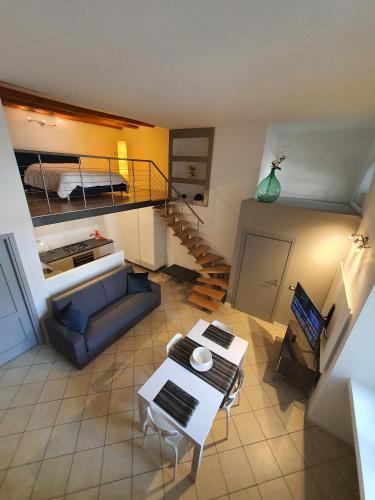a view of a living room with a couch and a staircase at Casa Bortolin in Domodossola