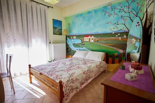 a bedroom with a bed with a dinosaur painting on the wall at Luxury 3 Bedroom Apartment with Garden in Chios