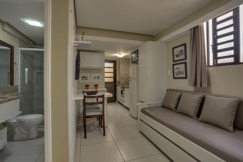 a living room with a couch and a table at Flat Pietra in Florianópolis
