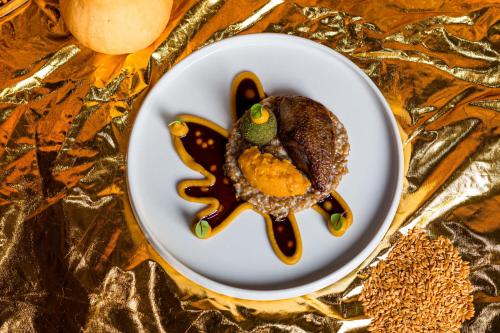 a plate with a cookie in the shape of a fish at Hôtel Saint-Alban in Nézignan-lʼÉvêque