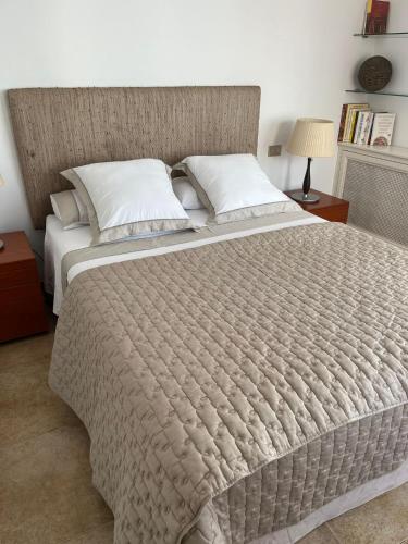 a large bed with a large comforter in a bedroom at FRENTE AL MAR in Burriana