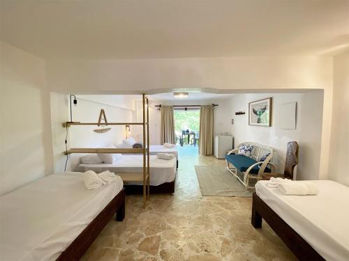 a bedroom with two beds and a living room at Surfbreak B&B in Cabarete