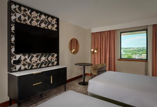 a hotel room with a bed and a flat screen tv at Doubletree By Hilton Sheffield City in Sheffield