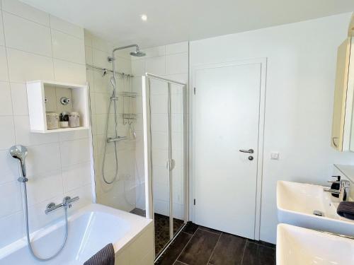 a bathroom with a shower and a tub and a sink at Fewo Bodenseeoase in Wangen