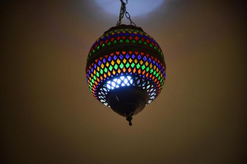 a colorful chandelier hanging from the ceiling at jaws wave imsouane in Imsouane