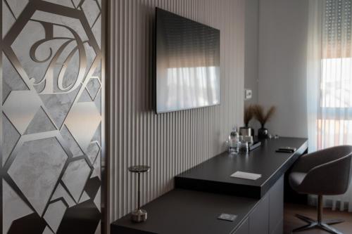a room with a desk with a mirror and a chair at Diamond Hotel in Zagreb