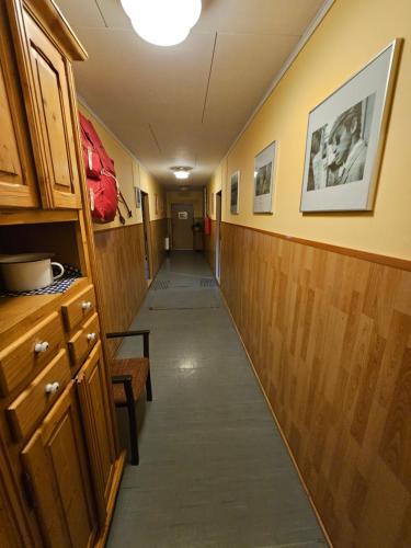 a hallway with a long hall with wooden walls at Penzion Poslední míle in Milovy