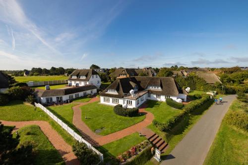 an aerial view of a house in a village at Haus Amanda in Norddorf