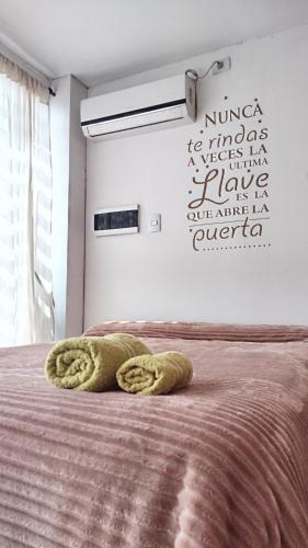 a bedroom with a bed with two towels on it at Casa Tulia 2 estadio único in La Plata