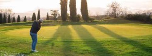 a woman is playing golf on a golf course at Villa Ada in Monsummano