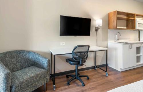 a room with a desk and a chair and a television at Extended Stay America Suites - Atlanta - McDonough in McDonough