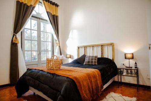 a bedroom with a bed and a large window at Piso 517 in San Fernando del Valle de Catamarca