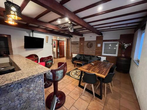 a kitchen and living room with a wooden table at C&A Apartments in Kaiserslautern