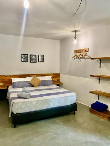 a bedroom with a large bed in a room at Casa Mosaiko Patio Bonito in Medellín