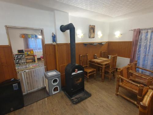 a wood stove in a room with a table at Vířivka a sauna na pokoji,nebo na vlastní terase - Farma u Příbrami in Příbram