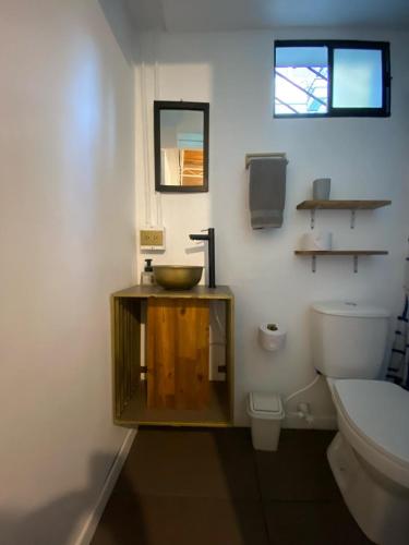 a bathroom with a sink and a toilet at Casa Mosaiko Patio Bonito in Medellín