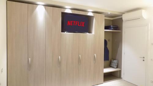 a wardrobe with a tv on top of it at MillyHolidays - Apartment Sunflower - Center - Nearby Beach - Private Garden - Spa Pool in Bardolino