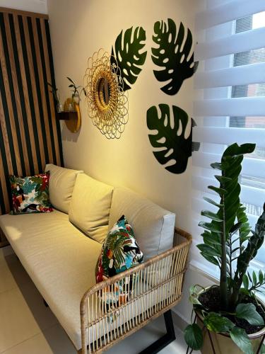 a living room with a couch and some plants at 'SELECT' Medellin in Medellín
